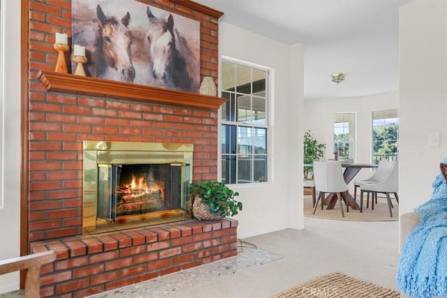 living room featuring carpet and a fireplace