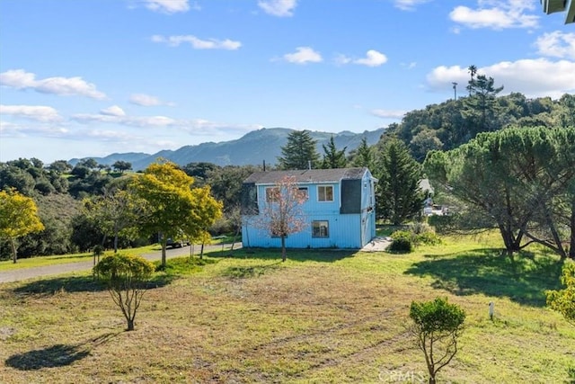 exterior space featuring a mountain view, a yard, and a rural view