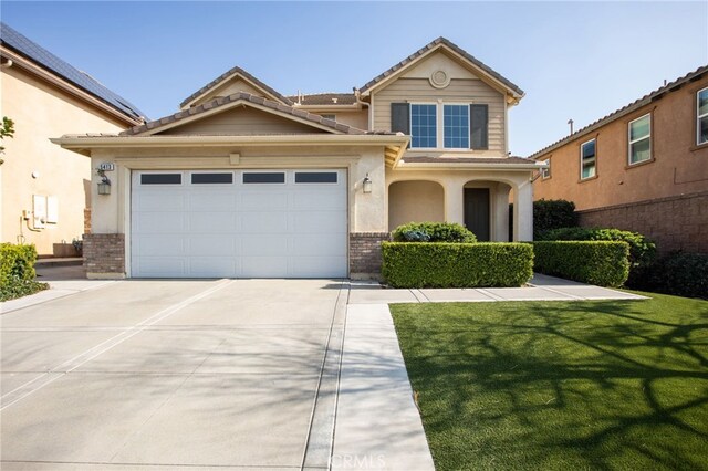 view of front of house with a garage and a front yard