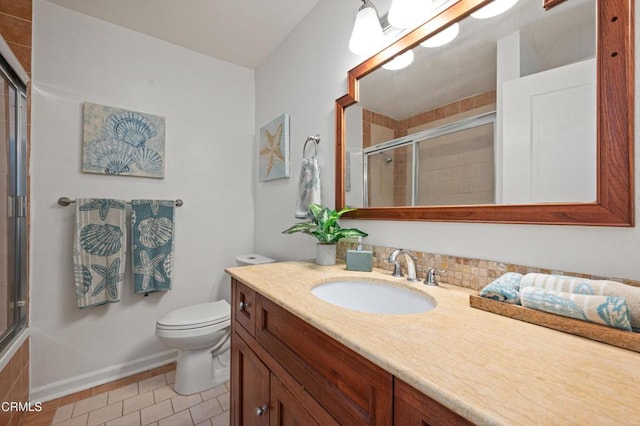 bathroom with tile patterned flooring, toilet, walk in shower, and vanity