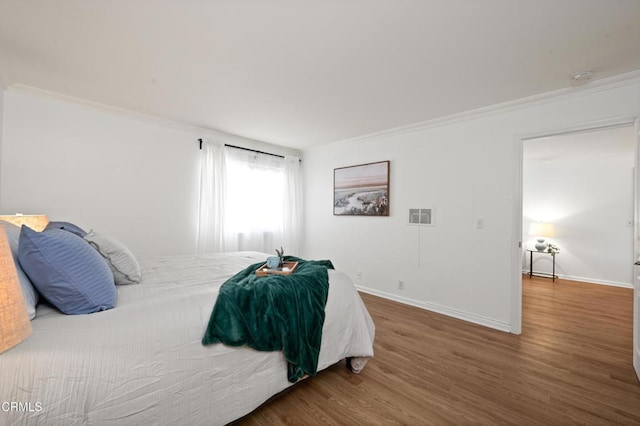 bedroom featuring dark hardwood / wood-style flooring and crown molding