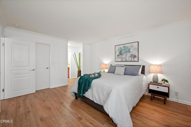 bedroom featuring wood-type flooring and ornamental molding