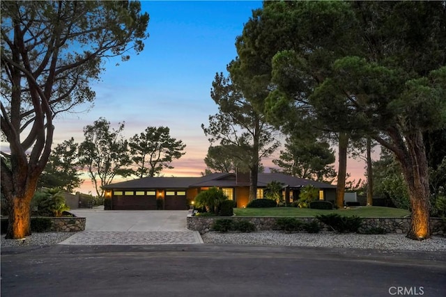 view of front of house featuring a garage and a yard