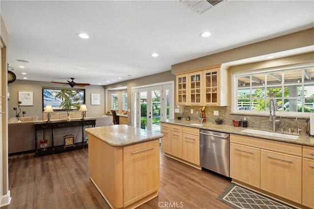 kitchen with dishwasher, a kitchen island, french doors, light brown cabinetry, and sink