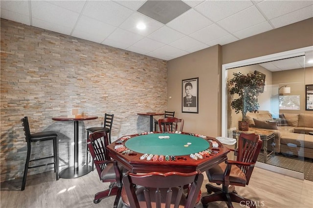 playroom with a paneled ceiling and hardwood / wood-style floors