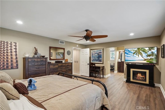 bedroom with ceiling fan and light hardwood / wood-style floors