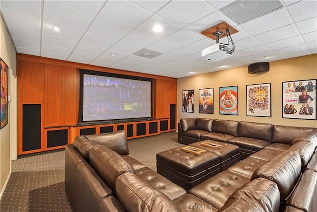 cinema room with carpet flooring and a drop ceiling