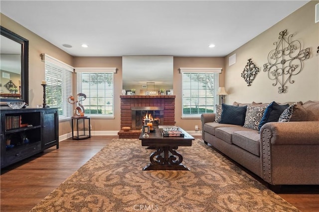 living room featuring dark hardwood / wood-style floors and a fireplace