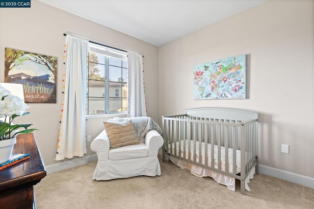 carpeted bedroom featuring a crib