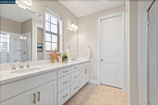 bathroom featuring a shower with door, vanity, and tile patterned flooring