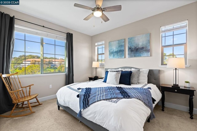 bedroom featuring light carpet and ceiling fan