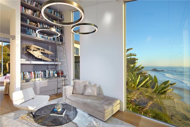 interior space featuring a water view, wood-type flooring, and built in shelves