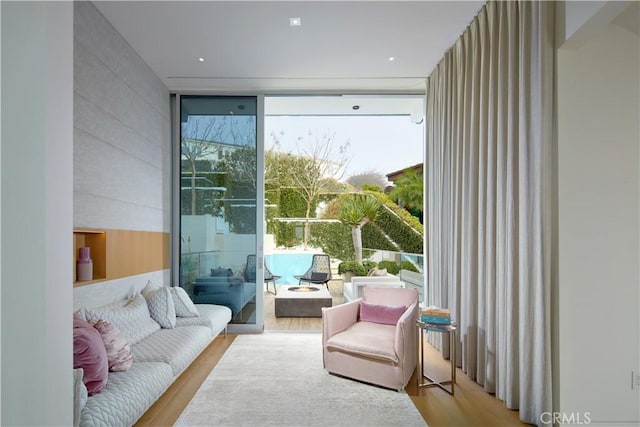 interior space with expansive windows and light hardwood / wood-style flooring