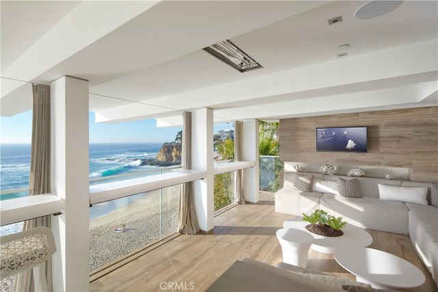 sunroom / solarium featuring a water view