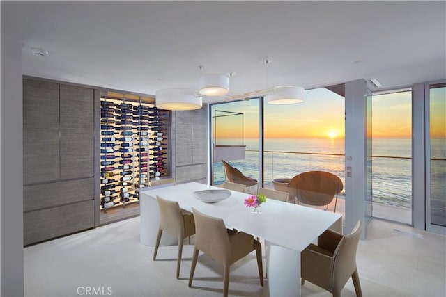 dining space with a water view and a wall of windows