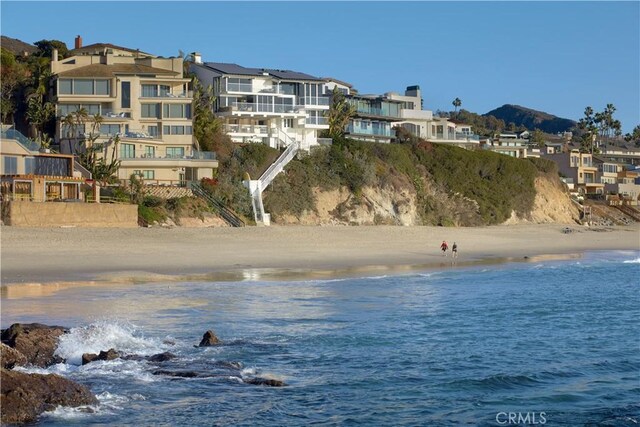 water view featuring a beach view and a mountain view