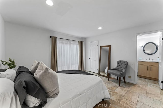 bedroom featuring ensuite bathroom and sink