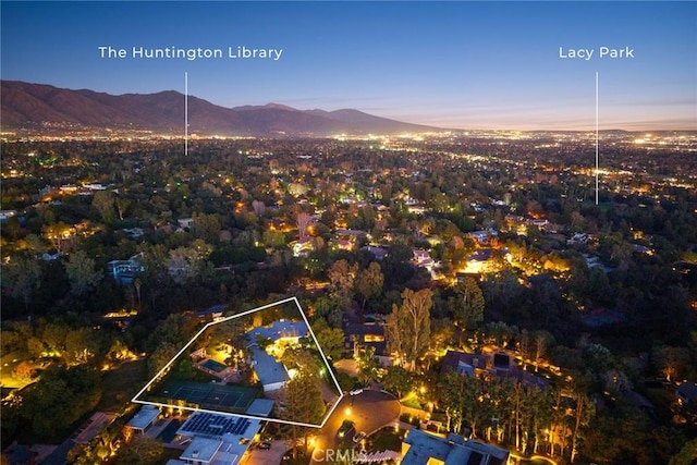 aerial view at dusk featuring a mountain view