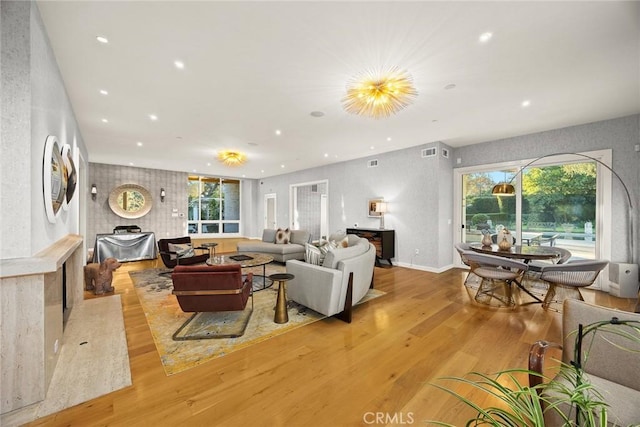 living room with plenty of natural light and light hardwood / wood-style flooring