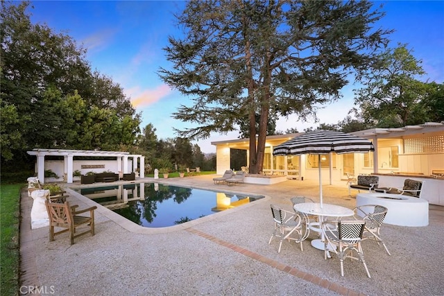 pool at dusk featuring a pergola and a patio