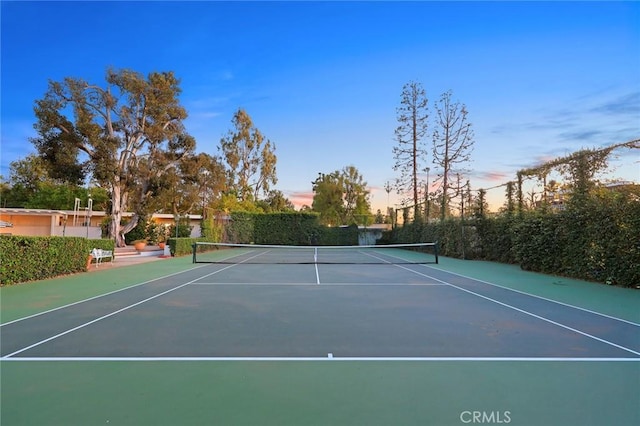 view of tennis court with basketball hoop