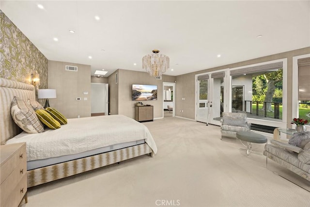 bedroom with light colored carpet and a chandelier