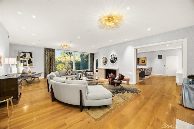 living room with expansive windows and light hardwood / wood-style floors