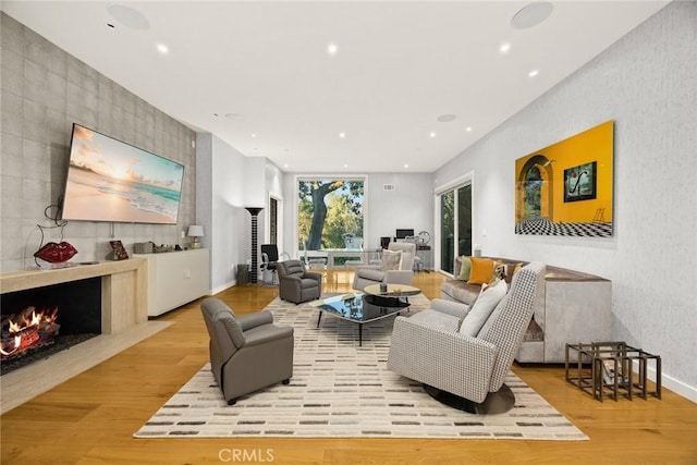 living room with a fireplace and light hardwood / wood-style floors