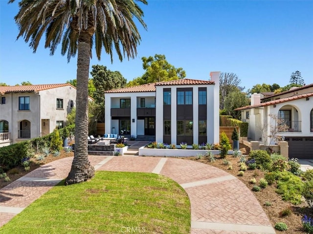 mediterranean / spanish-style home with a front yard