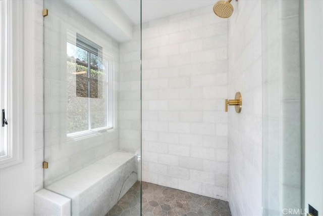 bathroom with a tile shower