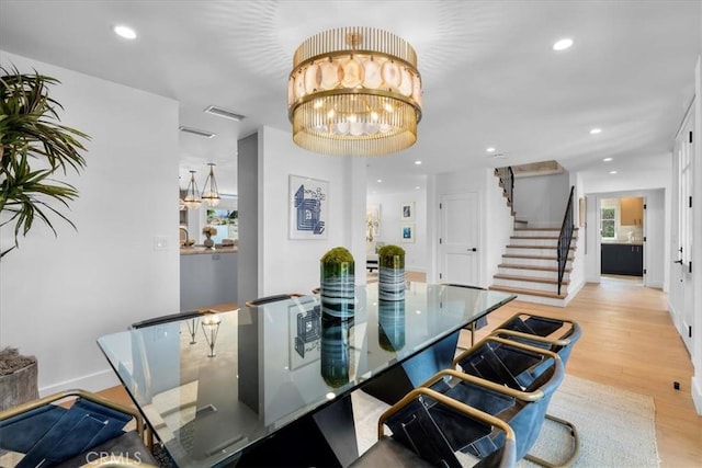 dining room featuring an inviting chandelier and light wood-type flooring