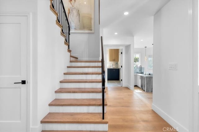 stairs featuring wood-type flooring