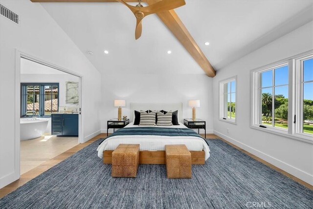 bedroom with ceiling fan, vaulted ceiling, multiple windows, and light wood-type flooring