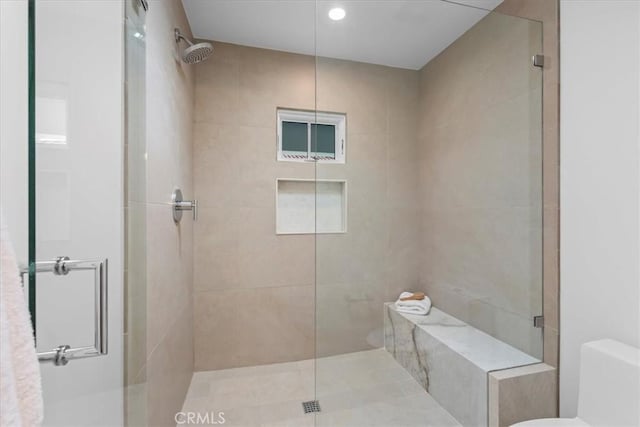 bathroom with walk in shower and toilet