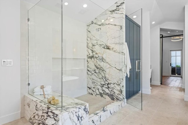 bathroom with tile patterned floors and a tile shower