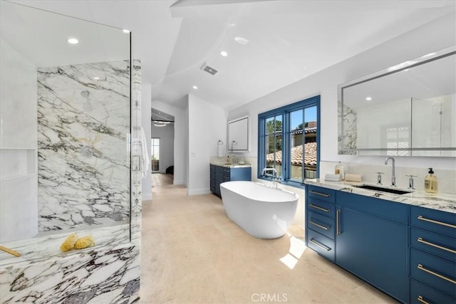 bathroom featuring vanity, lofted ceiling, and plus walk in shower