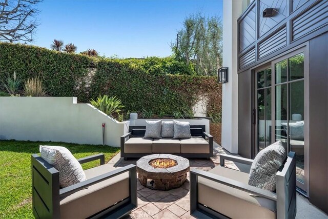 view of patio featuring an outdoor living space with a fire pit