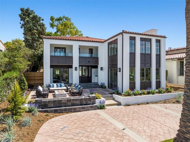 back of property featuring an outdoor hangout area and a patio area