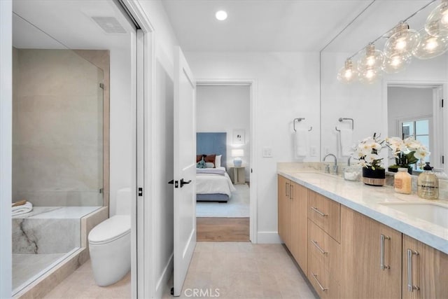 bathroom with walk in shower, vanity, tile patterned floors, and toilet