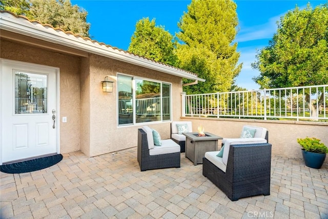 view of patio / terrace with an outdoor fire pit