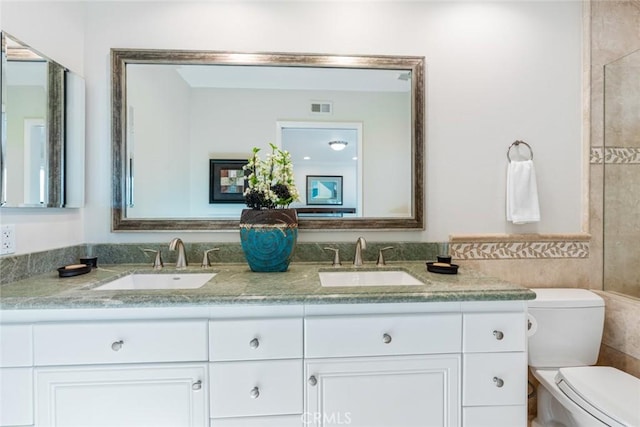 bathroom with toilet and vanity