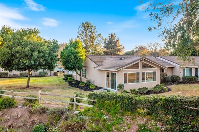 rear view of house with a yard