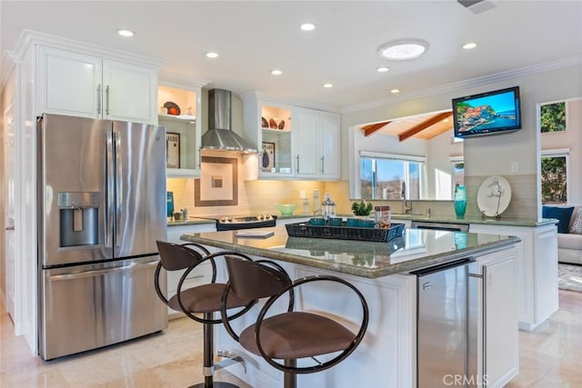 kitchen with wine cooler, a center island, white cabinetry, stainless steel fridge with ice dispenser, and wall chimney exhaust hood