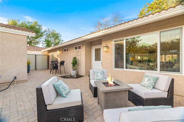 view of patio / terrace with an outdoor living space with a fire pit