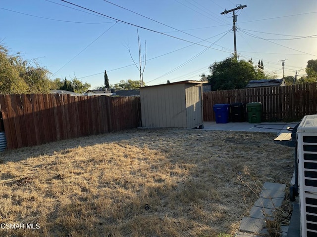 view of yard featuring a shed and a patio