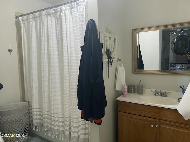 bathroom with stacked washer / drying machine, vanity, and shower / bath combo