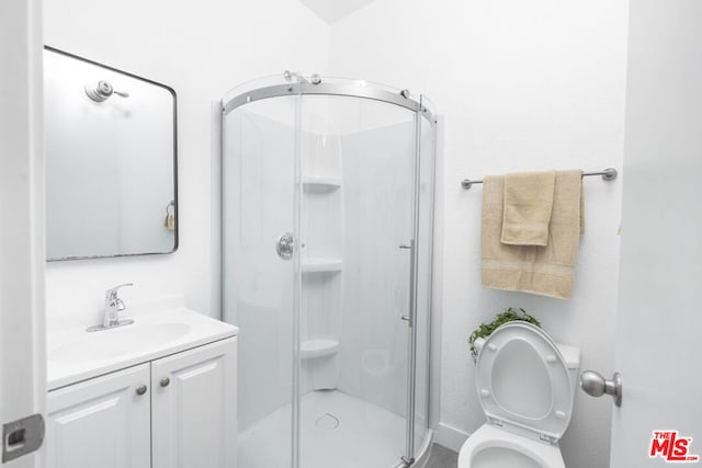 bathroom with walk in shower, vanity, and toilet