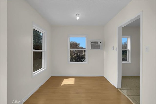 spare room with light hardwood / wood-style flooring and a wall mounted AC