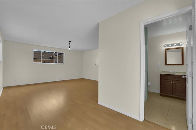 empty room with light hardwood / wood-style flooring