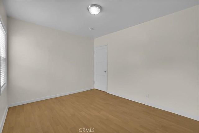 unfurnished room with hardwood / wood-style flooring